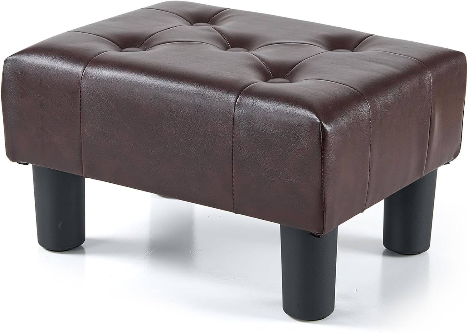 Small foot stool with legs, leather upholstered, stable construction for living room.