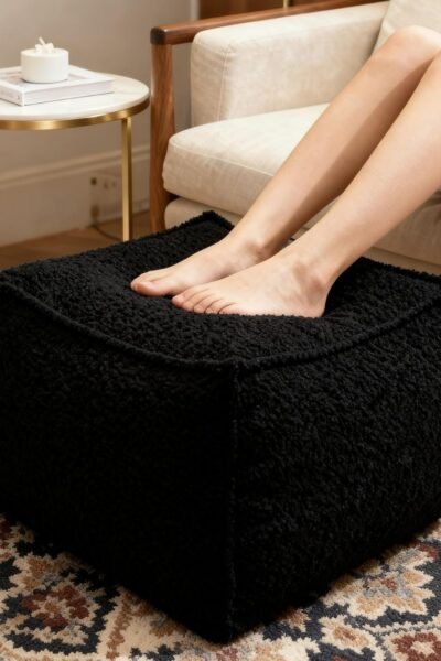 Square boucle pouf ottoman footrest, soft lightweight footstool with foam filling, laid-back lounge style.