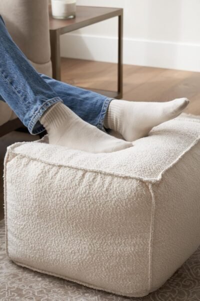 Round modern pouf ottoman, boucle upholstered, lightweight foam filled, foot rest for living room decor.